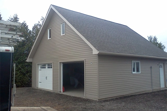 Close view of trim being carefully painted along house windows and eaves
