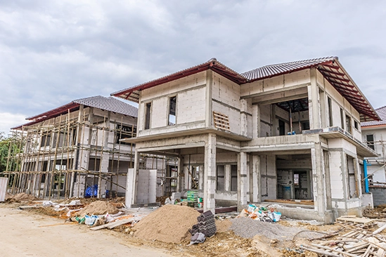 Newly built house exterior showing completed framing, sheathing, and roof structure