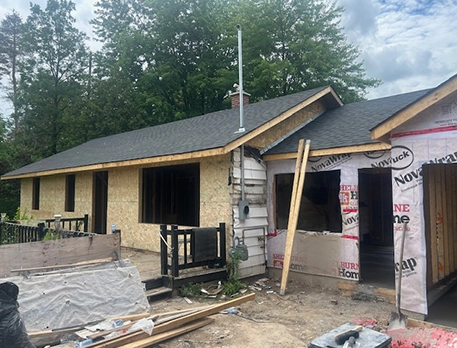 Renovations company team standing together inside finished residential remodeling project